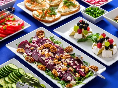 a buffet of food on a blue table at Kosmopolita Apartments in Kraków