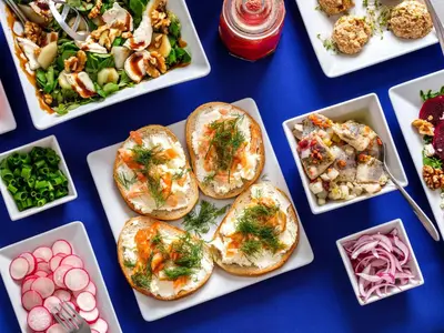 a table topped with plates of food and appetizers at Kosmopolita Apartments in Kraków
