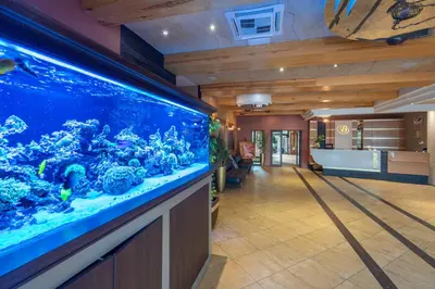 an aquarium in the middle of a room with a hallway at Hotel Badura in Wadowice