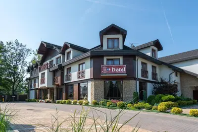 a hotel with a sign that reads the hotel at Hotel Badura in Wadowice