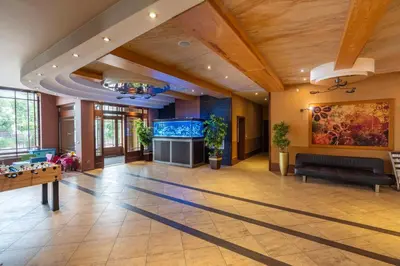 a large living room with a large aquarium at Hotel Badura in Wadowice