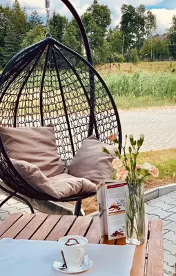 a swing chair sitting on top of a table at Hotel Komfort in Krzywaczka