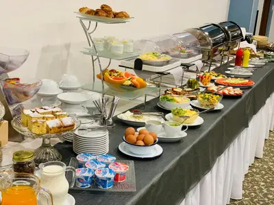 a buffet line with many plates of food on it at Hotel Komfort in Krzywaczka