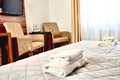 a hotel room with two beds with towels on them at Hotel Komfort in Krzywaczka