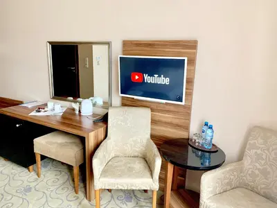 a room with a desk with a monitor and chairs at Hotel Komfort in Krzywaczka