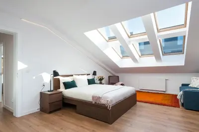 a bedroom with a large bed with skylights at Old Town, Kazimierz, large luxurious, 2 bedroom 2 bathroom, Airco in Kraków