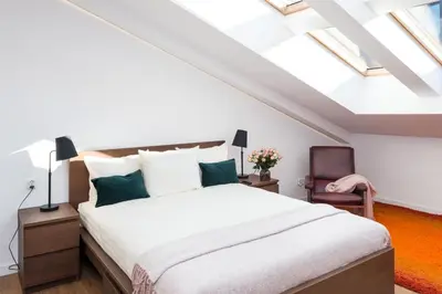 a bedroom with a bed in a attic with skylights at Old Town, Kazimierz, large luxurious, 2 bedroom 2 bathroom, Airco in Kraków