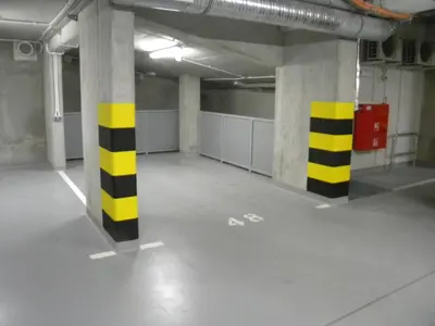 an empty parking garage with yellow and black columns at Old Town, Kazimierz, large luxurious, 2 bedroom 2 bathroom, Airco in Kraków