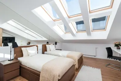 two beds in a attic room with skylights at Old Town, Kazimierz, large luxurious, 2 bedroom 2 bathroom, Airco in Kraków
