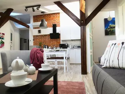 a living room with a couch and a table at Apartament krakowski GIMO na Kazimierzu in Kraków