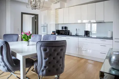 a kitchen with a dining room table and chairs at LUXURIOUS APARTMENTS Cracow in Kraków