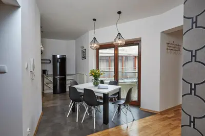 a dining room with a white table and chairs at LUXURIOUS APARTMENTS Cracow in Kraków