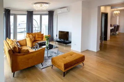 a living room with a couch and a table at LUXURIOUS APARTMENTS Cracow in Kraków