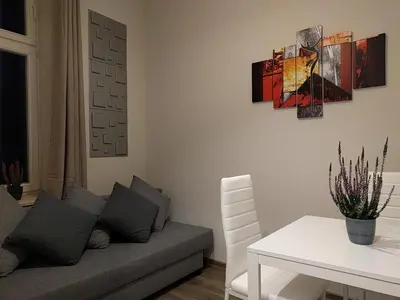 a living room with a couch and a table at OldKrak Apartment in Kraków