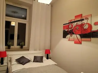 a bedroom with a bed and a window at OldKrak Apartment in Kraków