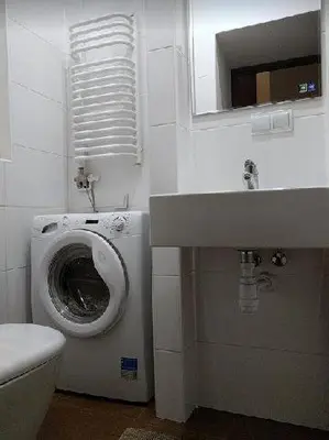 a bathroom with a toilet and a sink at OldKrak Apartment in Kraków