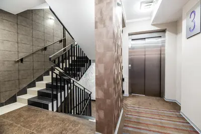 a hallway with a staircase and a door at Hotel Perfect in Kraków
