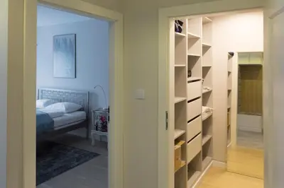 a bedroom with a bed and a closet at Chopin Apartments in Kraków
