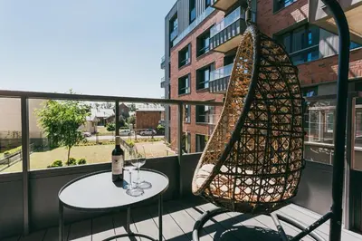a table and chairs on a balcony with a bottle of wine at Eight Lux View in Old Town and Free Parking in Kraków