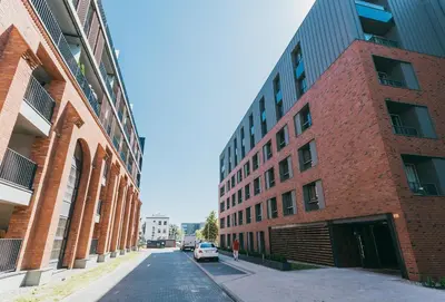 an empty street between two large brick buildings at Eight Lux View in Old Town and Free Parking in Kraków