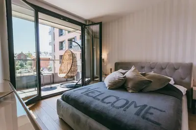 a bedroom with a couch and a large window at Eight Lux View in Old Town and Free Parking in Kraków