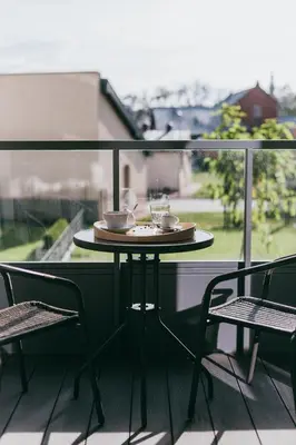 a table and two chairs on a balcony at Eight Lux View in Old Town and Free Parking in Kraków