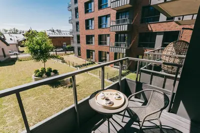 a balcony with a table and chairs on a building at Eight Lux View in Old Town and Free Parking in Kraków