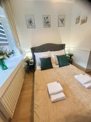 a bedroom with a large bed with towels on it at Great Polonia Kraków City Center in Kraków