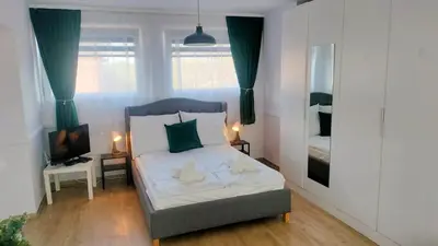 a small bedroom with a bed and a television at Great Polonia Kraków City Center in Kraków