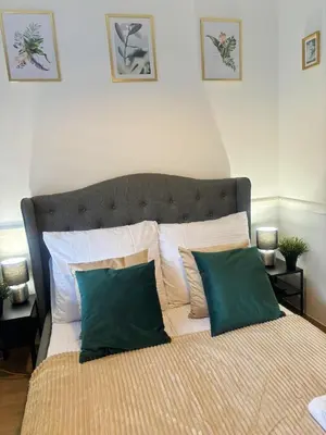 a bed with two green pillows on top of it at Great Polonia Kraków City Center in Kraków