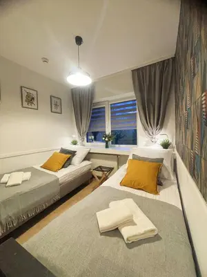 a bedroom with two beds and a window at Great Polonia Kraków City Center in Kraków