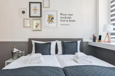 a bedroom with a bed with two towels on it at Great Polonia Kraków City Center in Kraków