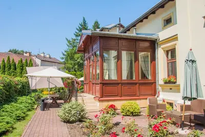 a house with a patio and an umbrella in the yard at U Pana Cogito in Kraków