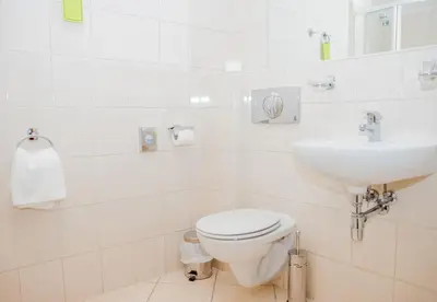 a white bathroom with a toilet and a sink at U Pana Cogito in Kraków
