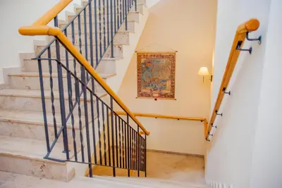 a staircase in a home with a painting on the wall at U Pana Cogito in Kraków