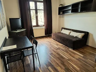 a living room with a couch and a table at Apartament Premium in Kraków