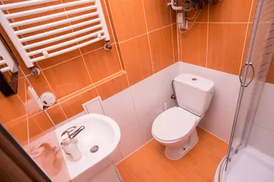 a small bathroom with a toilet and a sink at Apartament Premium in Kraków