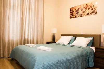 a bedroom with a bed with two towels on it at Sauna Luxurious Apartment in Kraków