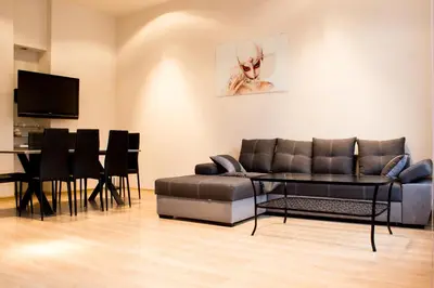 a living room with a couch and a table at Sauna Luxurious Apartment in Kraków