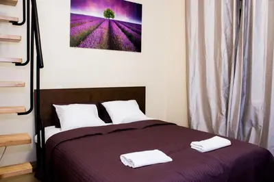 a bedroom with a bed with two towels on it at Sauna Luxurious Apartment in Kraków