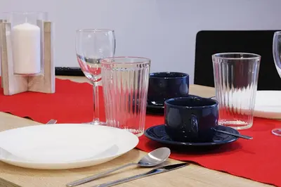 a table with glasses and a plate on a table at Apartment III GrayFor2 Old Town Kraków in Kraków