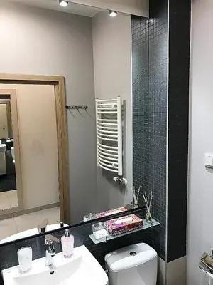 a bathroom with a toilet and a sink and a mirror at Apartment III GrayFor2 Old Town Kraków in Kraków