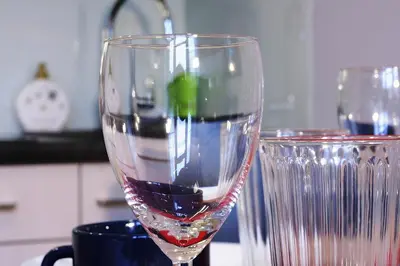 a wine glass sitting next to a cup on a counter at Apartment III GrayFor2 Old Town Kraków in Kraków