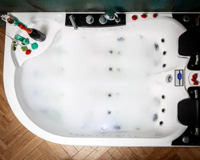 a white bathtub filled with paint and toys at Jacuzzi & Bike Apartment, Krakow in Kraków