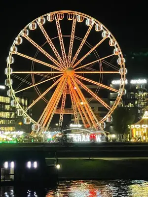 a large building with a clock tower at night at Jacuzzi & Bike Apartment, Krakow in Kraków