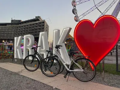 two bikes parked in front of a heart sign at Jacuzzi & Bike Apartment, Krakow in Kraków