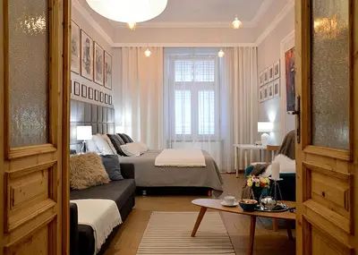 a living room with a bed and a couch in a room at Art Apartments w centrum Krakowa (Śródmieście, Stradom) in Kraków
