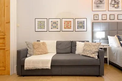 a living room with a couch and a bed at Art Apartments w centrum Krakowa (Śródmieście, Stradom) in Kraków