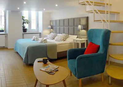a bedroom with a bed and a couch and a chair at Art Apartments w centrum Krakowa (Śródmieście, Stradom) in Kraków