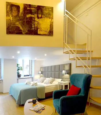 a bedroom with a bed and a chair at Art Apartments w centrum Krakowa (Śródmieście, Stradom) in Kraków